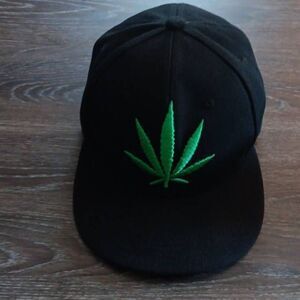 Cannabis Ball Cap  One Size Fits Most Black cap with standard plastic closure in